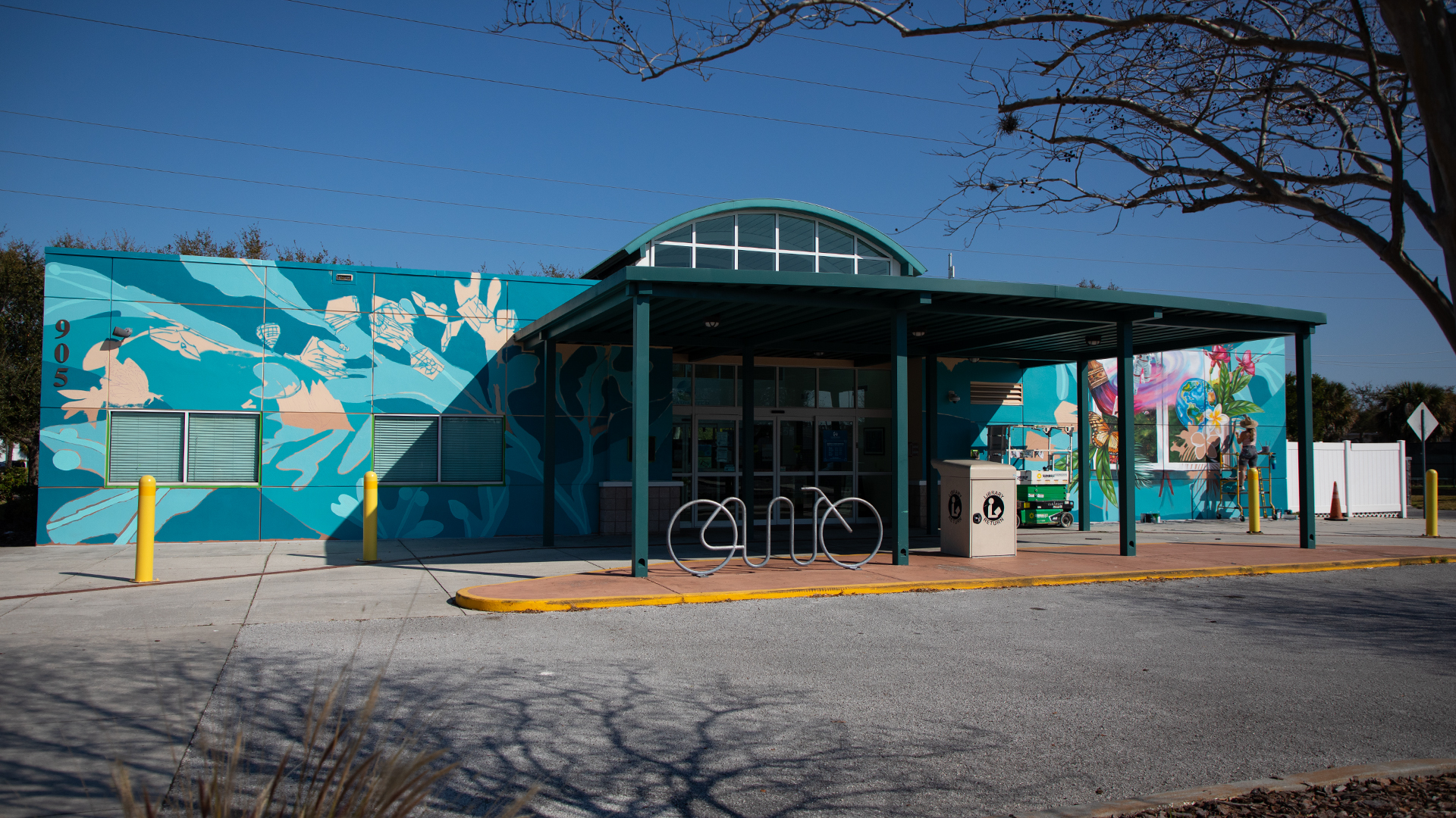 Exterior wall mural on Clearwater library at the entrance.