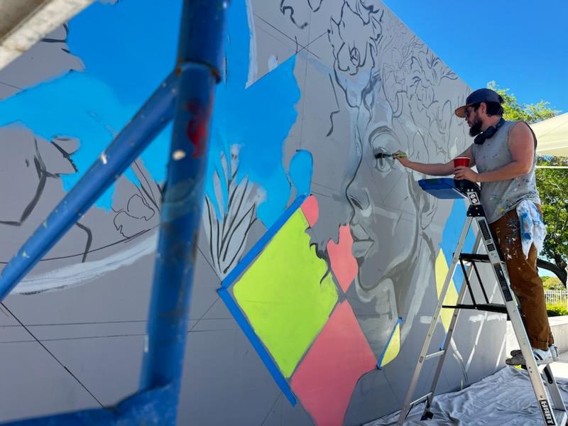 painter working on wall mural