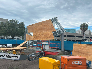 Construction site with containers and wood scattered around.