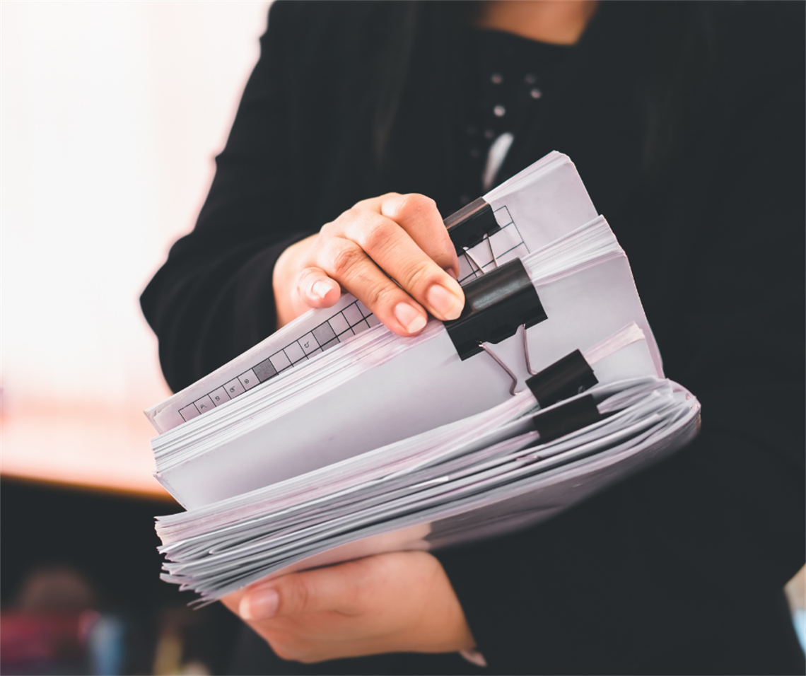 person who is checking a stack of files