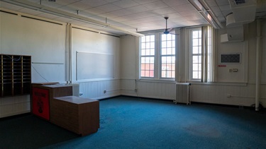 Empty room with white walls and blue carpet