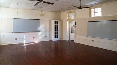Empty room with white walls and wood floor