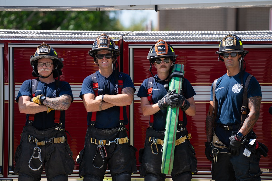 Firefighters in front of a fire engine.