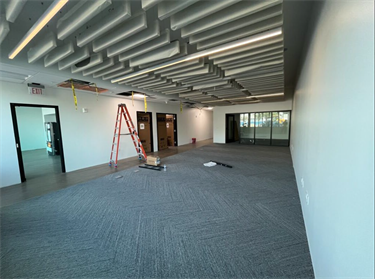 open office area with whit walls and grey floors