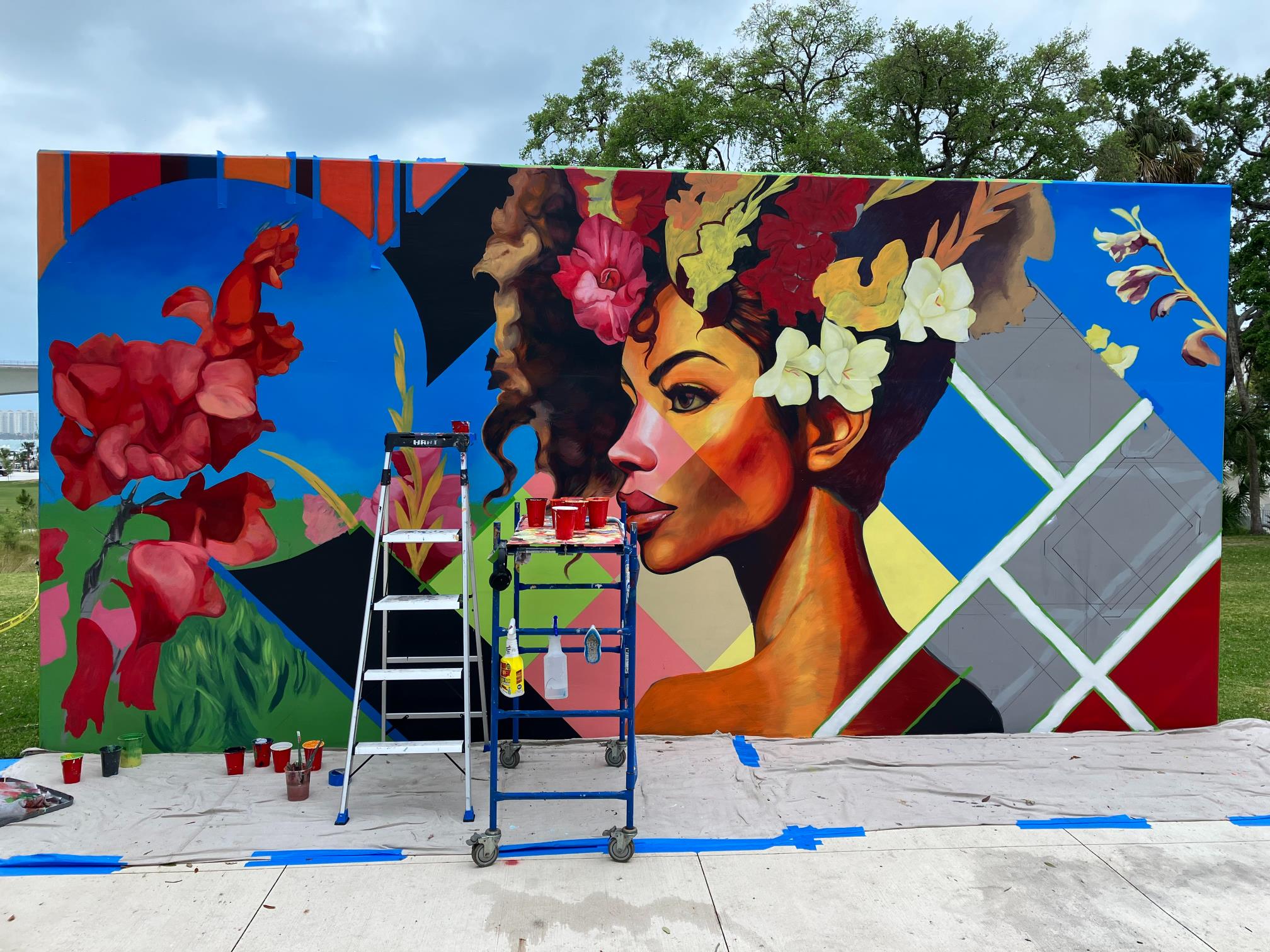 mural of a woman with flowers in her hair almost completed
