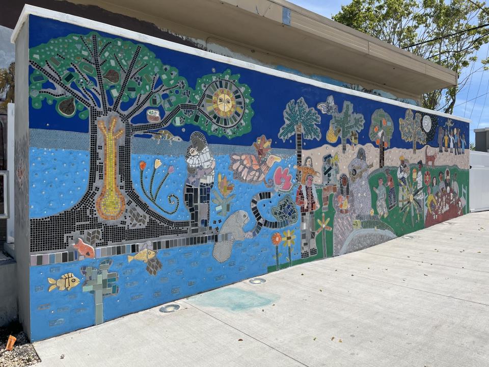 Mosaic style wall mural of people  celebrating.