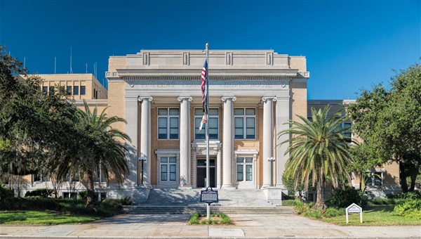 courthouse with flags in front of it