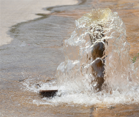 water leaking out of a water main break