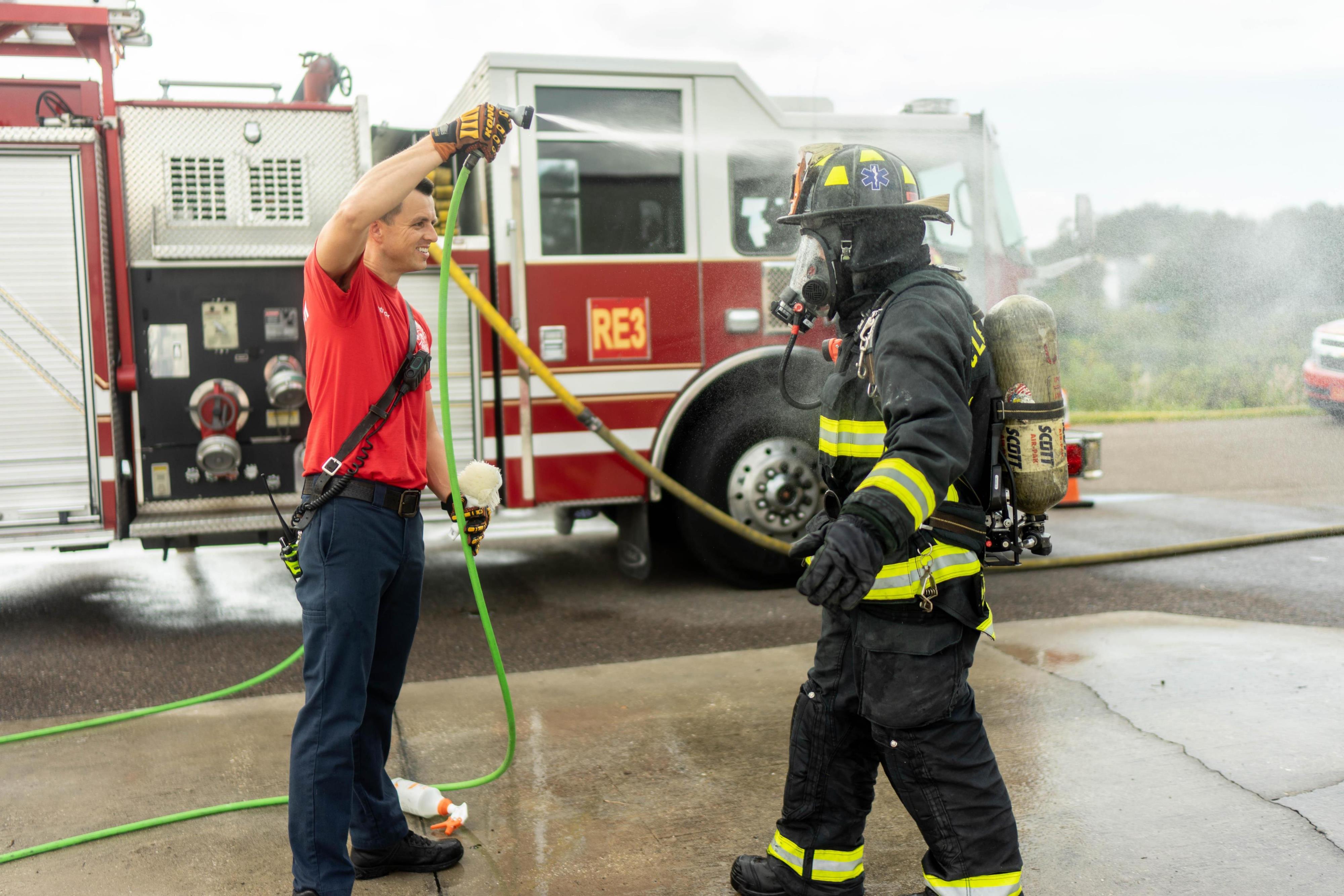 person being sprayed down from decontamination