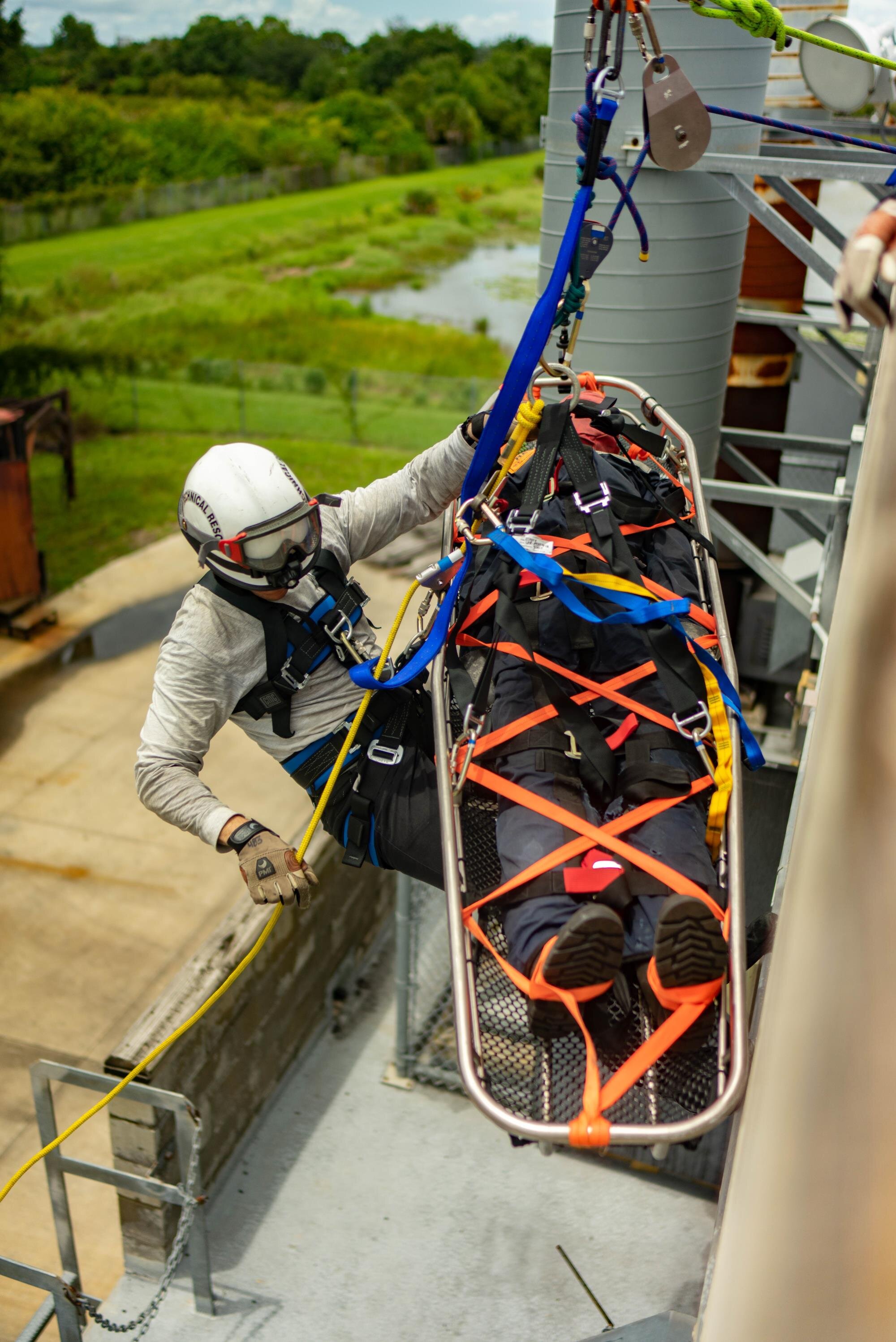 Image of a firefighter hanging from a building