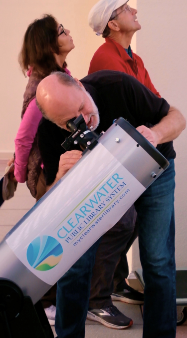 Library Division Manager David Stoner Operating a Telescope at Sunset on the Roof Event