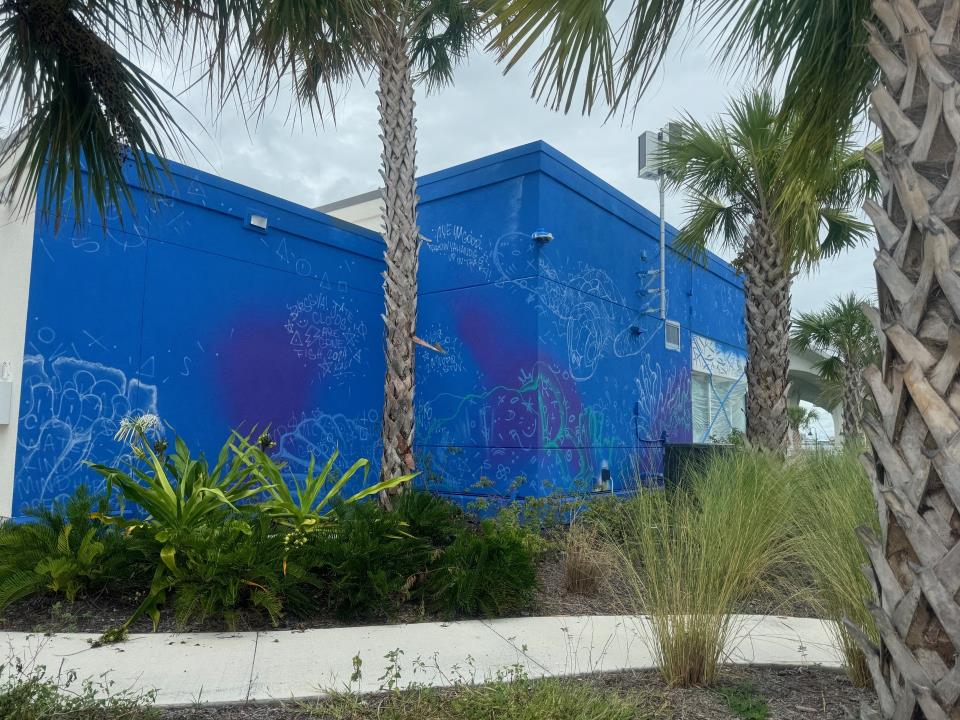 Building painted blue as the beginning of a mural.